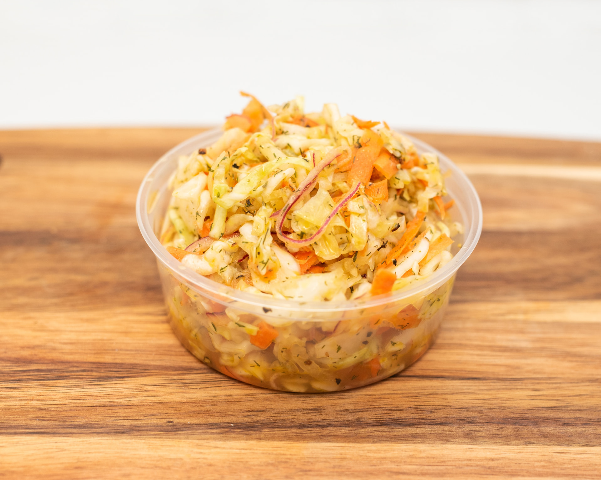 House-made coleslaw with cabbage, carrot and dill in a takeout cup